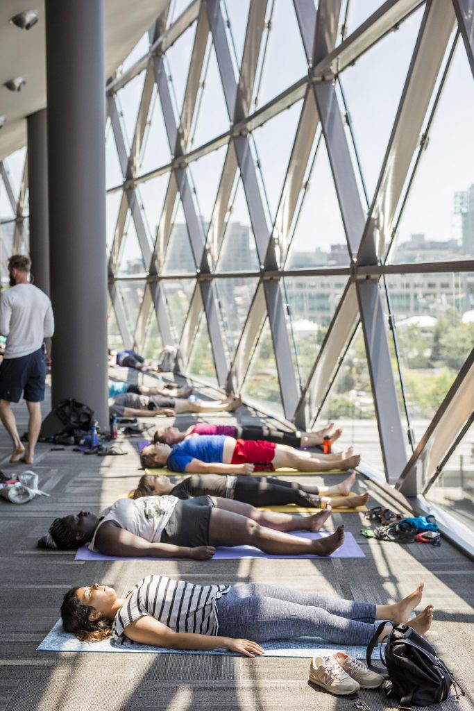 People lying on floor of Trillium Ballroom on yoga mats