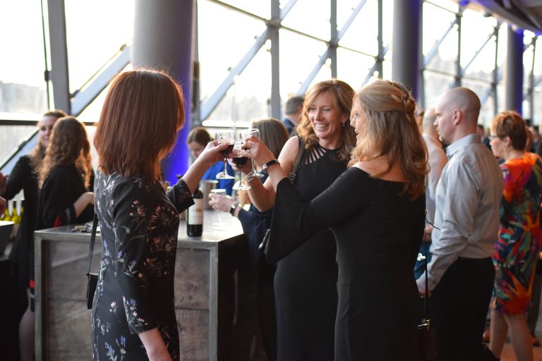 People celebrating with wine at event