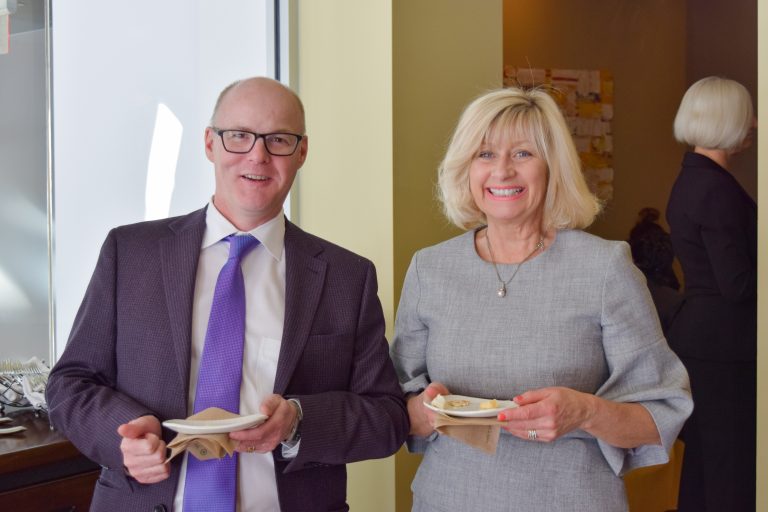 Two Shaw Centre Employees holding plates of food