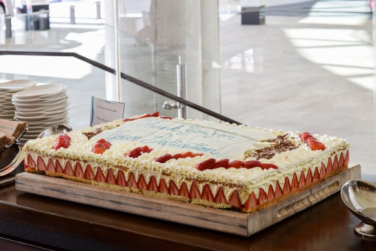 Strawberry Sheetcake that says "Thank you for Your Dedication"