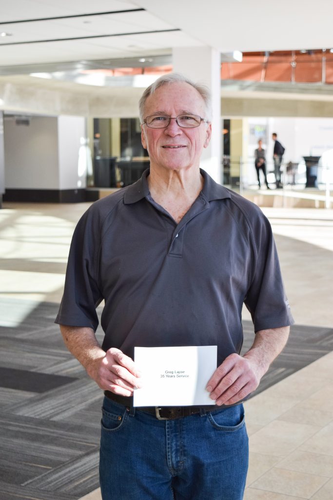 Greg holding Long Term Service name card