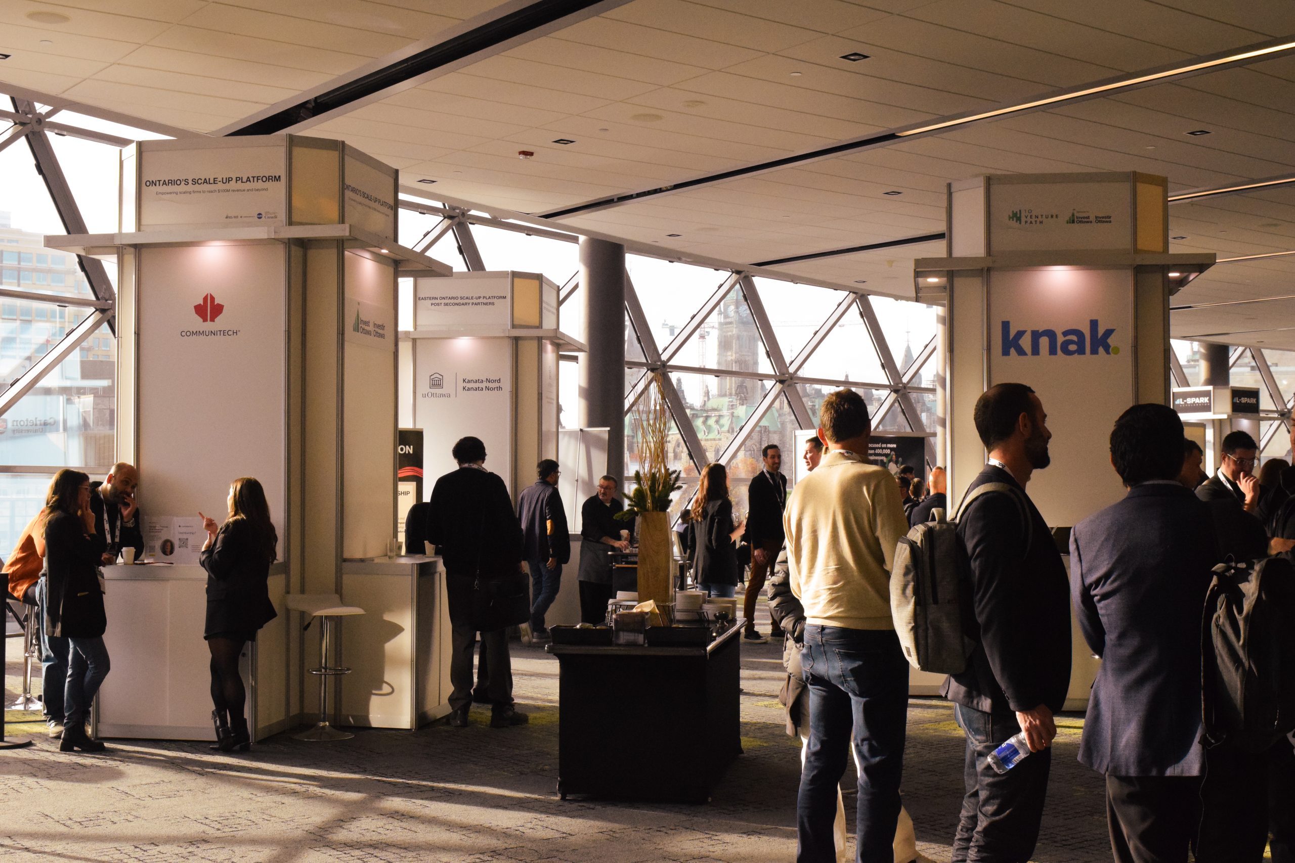 SAAS North conference attendees looking at booths/displays