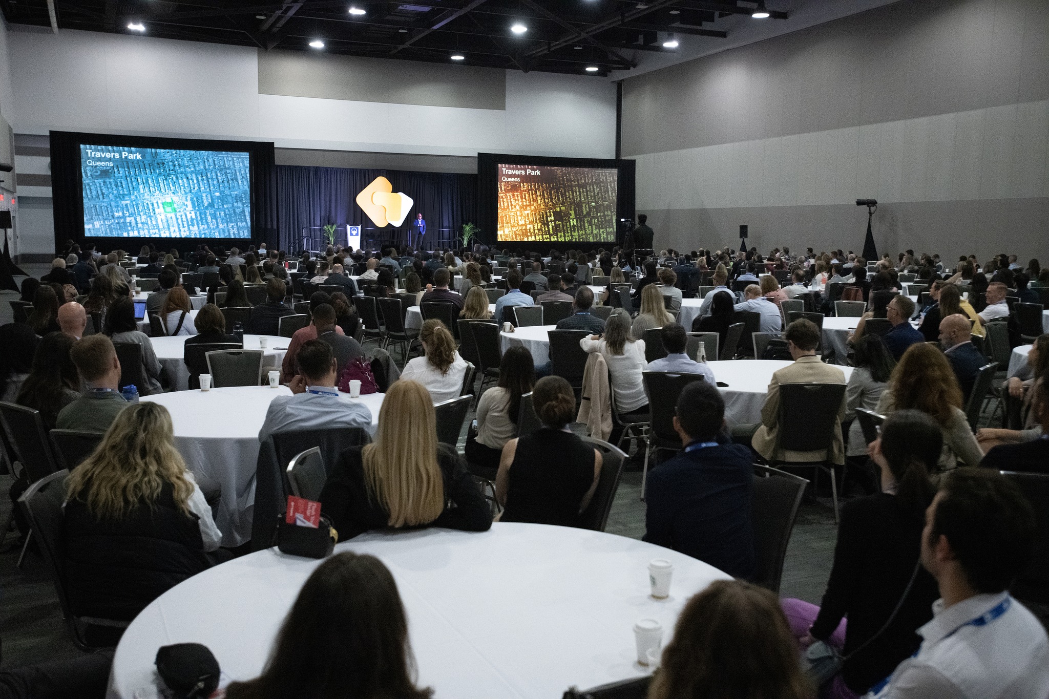 OPPI Conference. Attendees look toward the stage in round tables