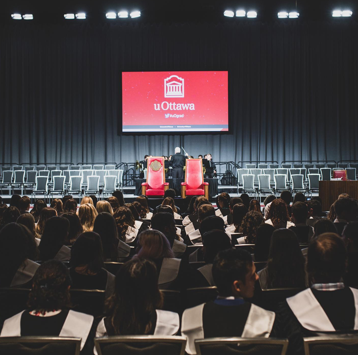 OttawaU Graduation, students sitting in their chairs facing the empty stage