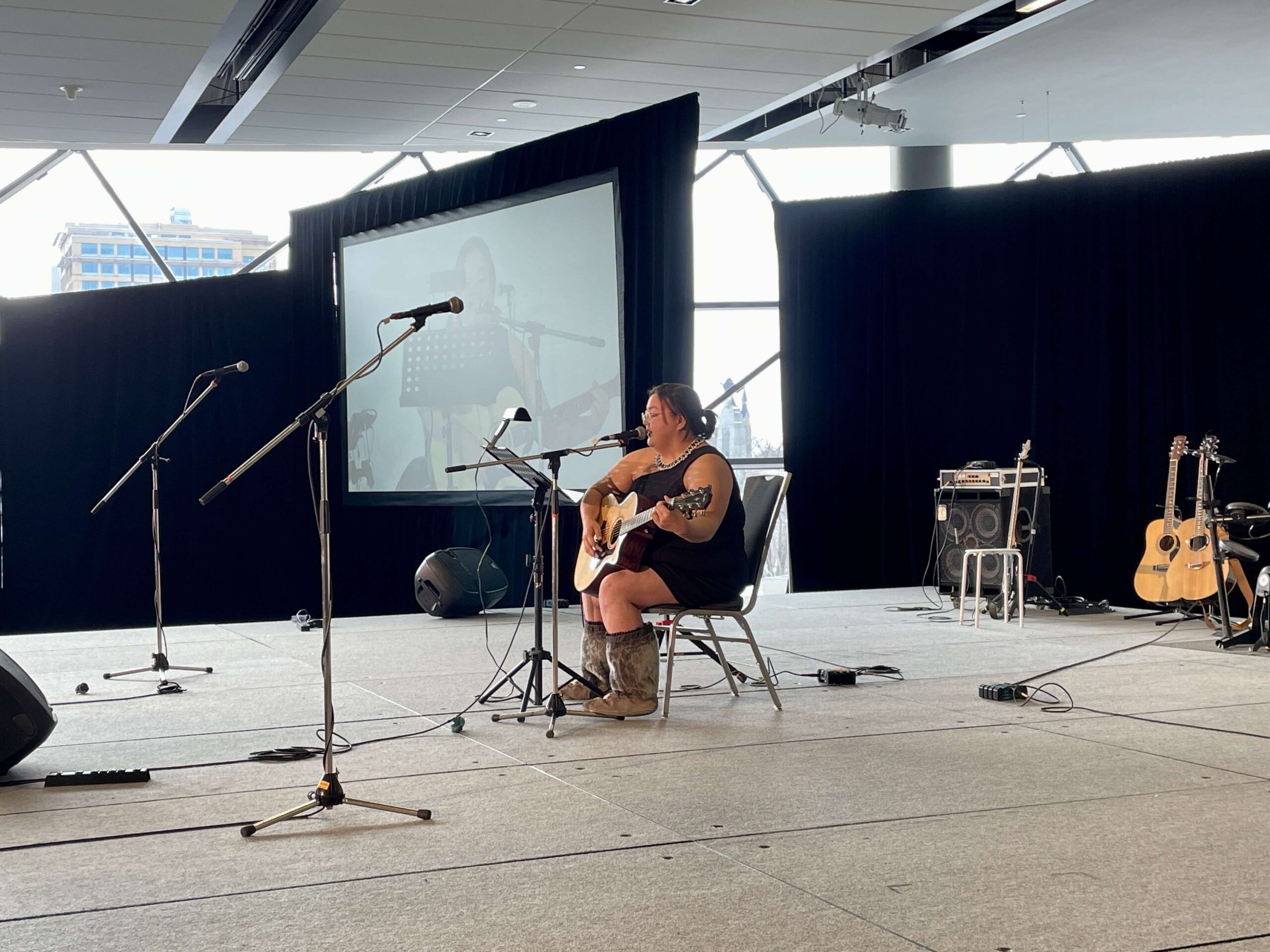 women playing guitar on stage