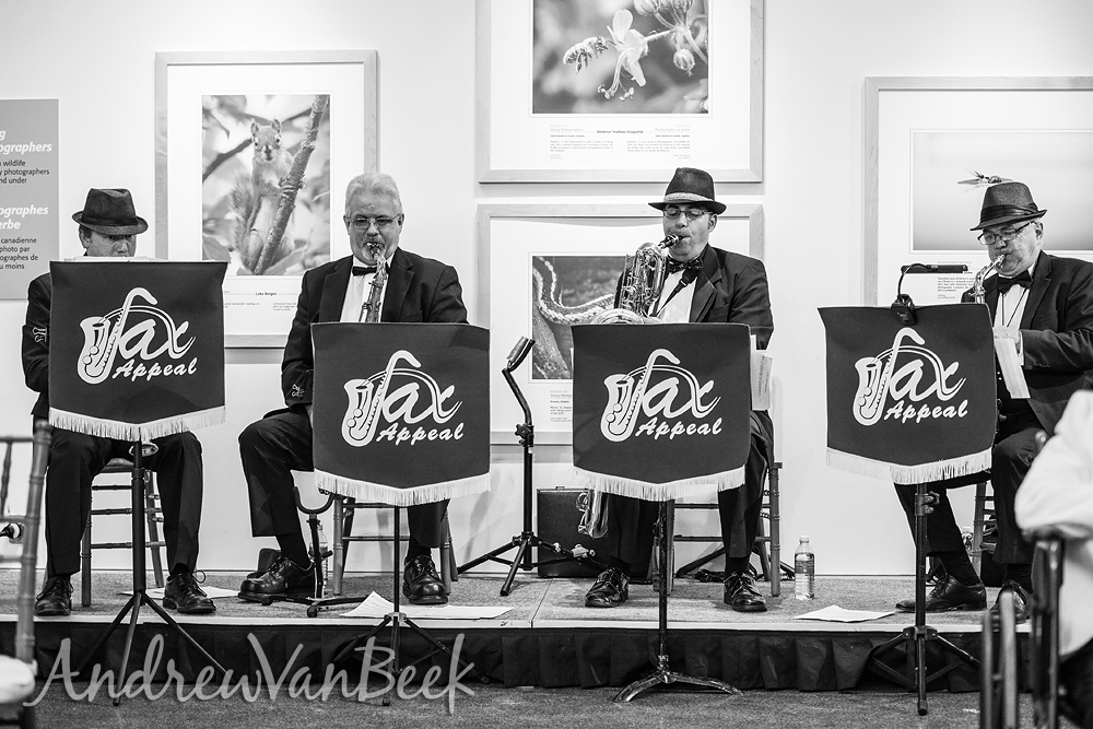4 men at a wedding performing with saxophones.