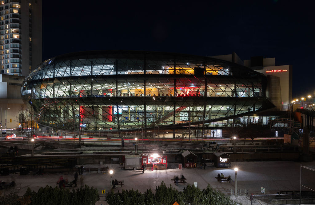 Exterior image of the Rogers Centre at night with the Rideau Canal.